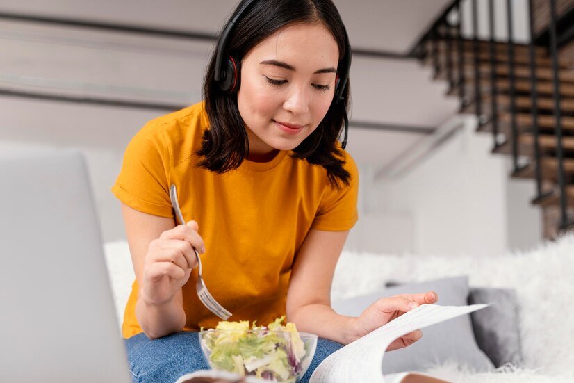 woman-with-headset-eating-while-attending-video-call